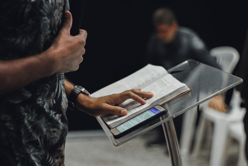 A pastor preaching passionately from the pulpit with congregation listening